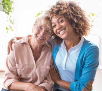 caregiver and elderly woman smiling